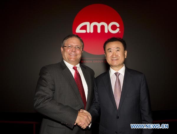 (120905) -- LOS ANGELES, Sept. 5, 2012 (Xinhua) -- Chairman and President Wang Jianlin (R) of China's Dalian Wanda Group Co. and AMC chief executive officer and president Gerry Lopez attend a press conference at an AMC theater in west Los Angeles, the United States, on Sept. 4, 2012. China's leading private conglomerate Dalian Wanda Group Co. on Tuesday completed a high-profile acquisition of AMC Entertainment Holdings, Inc., valued at roughly 2.6 billion U.S. dollars, in Los Angeles. (Xinhua/Zhao Hanrong) (nxl)