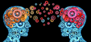 Teamwork and Leadership with education symbol represented by two human heads shaped with gears with red and gold brain idea made of cogs representing the concept of intellectual communication through technology exchange.